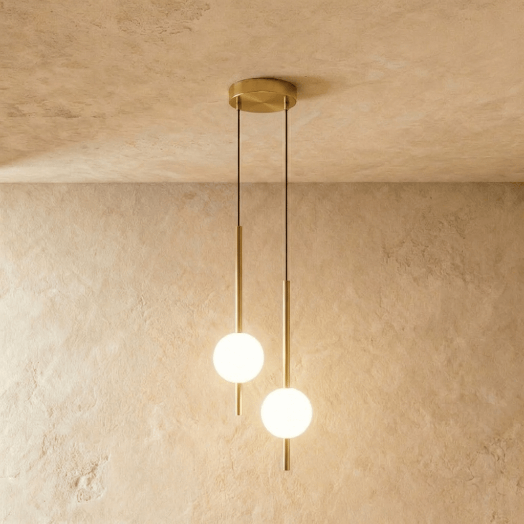 Clérachic twin-head orb pendant light in brushed brass, two rods and globes dropping from one round canopy.