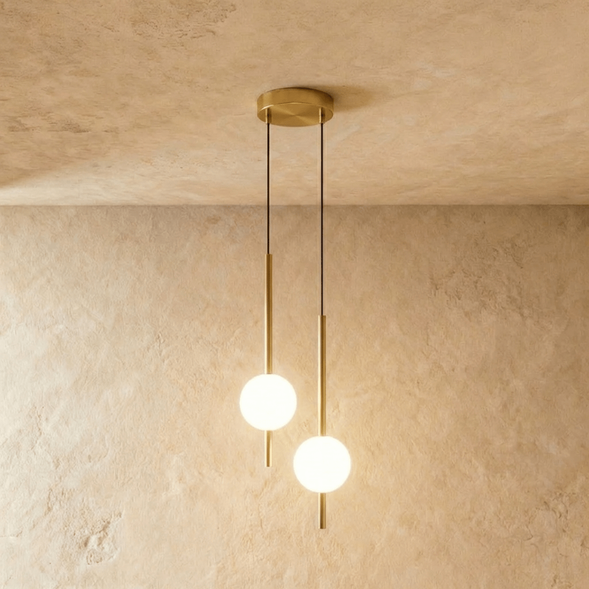Clérachic twin-head orb pendant light in brushed brass, two rods and globes dropping from one round canopy.
