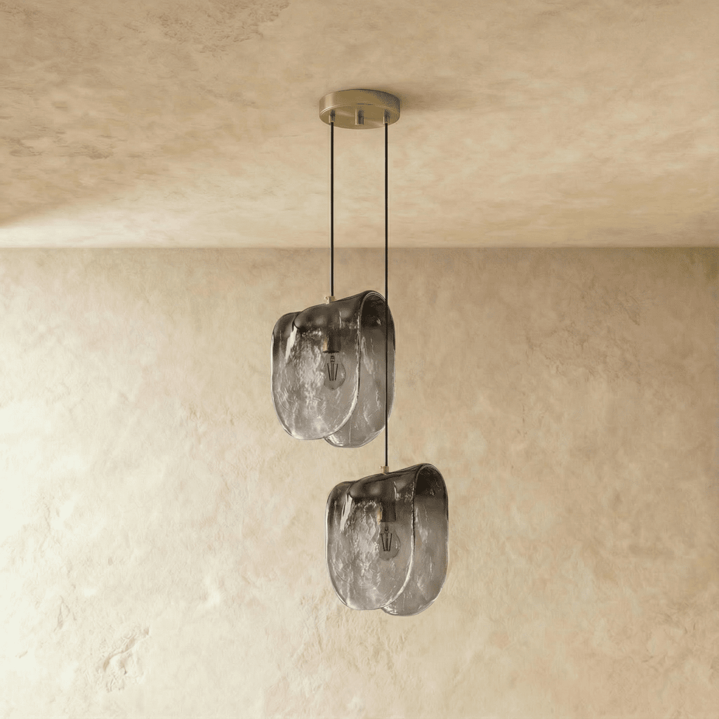 Clérachic two-head pendant of folded smoke-grey glass shades at staggered heights from one round ceiling canopy.