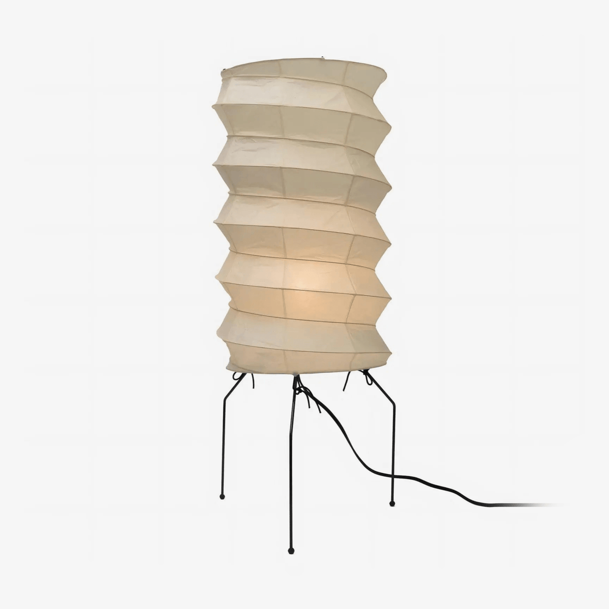 Clérachic pleated rice-paper floor lamp photographed head-on, the bulb's warm glow gathered in the middle tiers of the paper column.