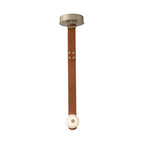 Studio front view of the Clérachic Orinos pendant: a riveted cognac strap carrying one alabaster disc from a brass canopy.