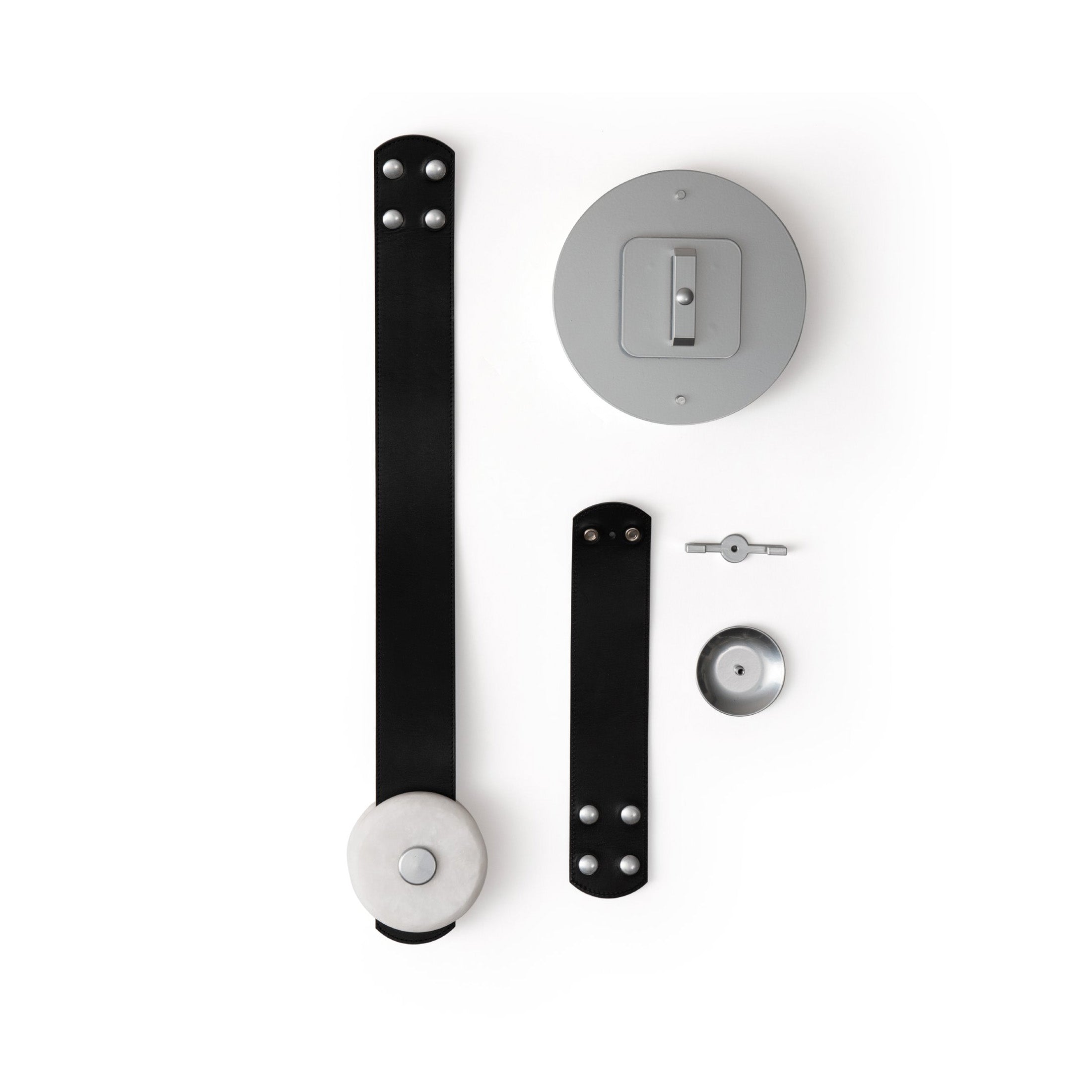 Clérachic Orinos parts laid out flat: black leather straps, the ceiling canopy plate, alabaster head and fixings.