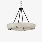 The Clérachic Orion alabaster chandelier with its black chain and canopy above the stone bowl.