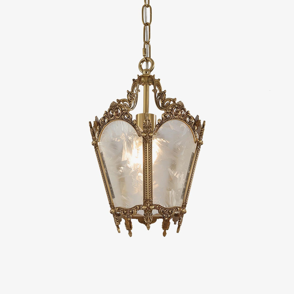 Ornate brass lantern pendant with frosted white glass panes, hung on a fine chain against a plain white backdrop, from Clérachic.