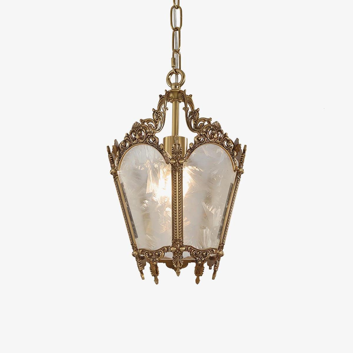 Ornate brass lantern pendant with frosted white glass panes, hung on a fine chain against a plain white backdrop, from Clérachic.