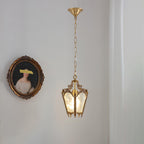 Brass lantern on a chain below a round brass canopy, hung on a pale wall beside an oval portrait, from Clérachic.