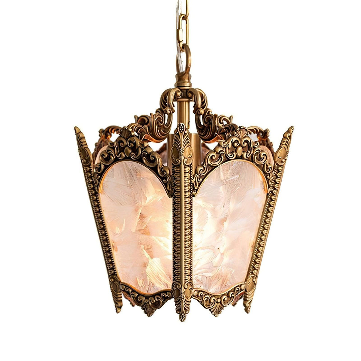 Brass lantern with scrolled frame and frosted panes with a soft pink tint, on a plain white backdrop, from Clérachic.