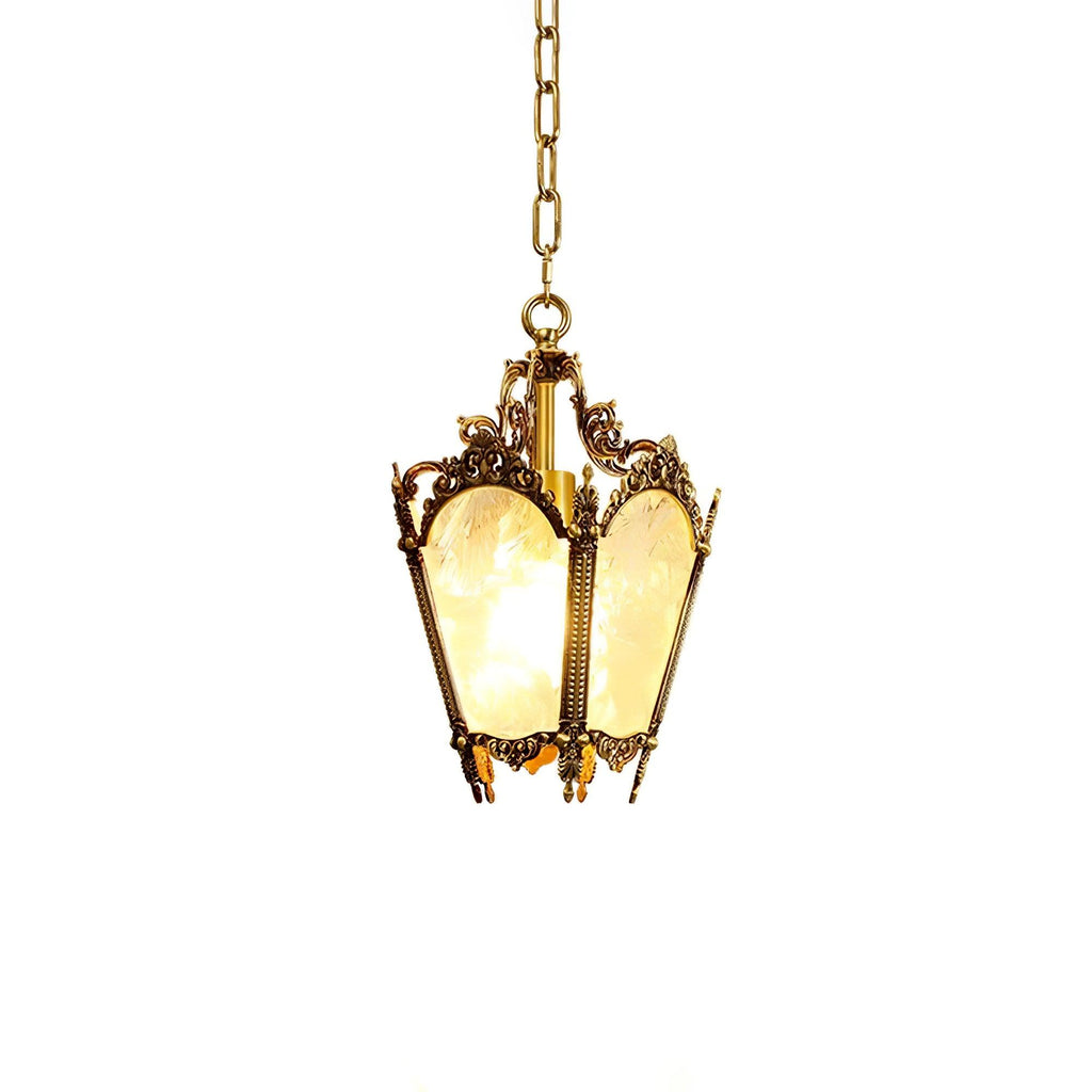 Brass lantern pendant on a chain with a hint of warm glow through the frosted panes, on white, from Clérachic.