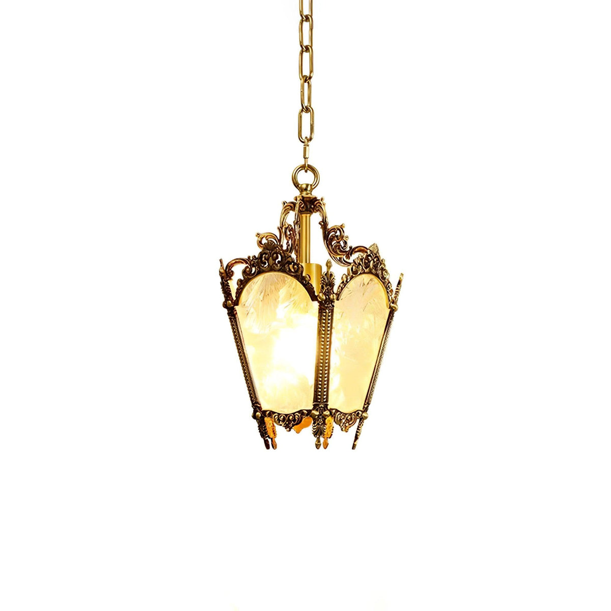 Brass lantern pendant on a chain with a hint of warm glow through the frosted panes, on white, from Clérachic.