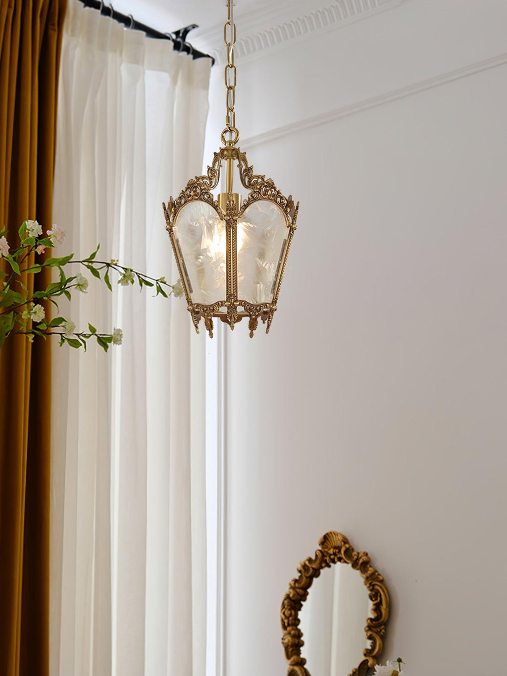 Small view of this Clérachic brass lantern pendant hung beside white curtains, an oval mirror at the lower edge.
