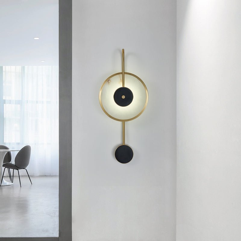 The Clérachic Orphaa fitted in an open hallway, brass stem and marble drop framed against a bright living space beyond.