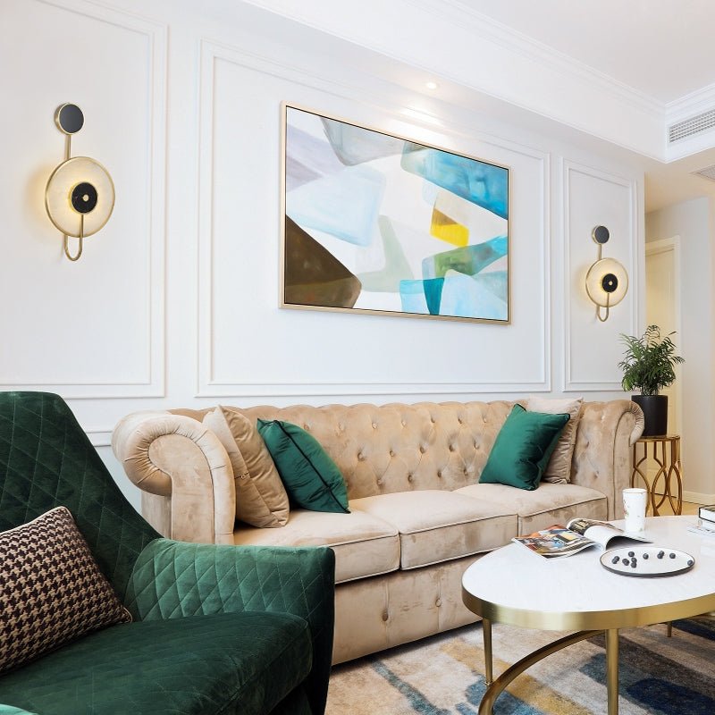 Clérachic Orphaa installed as a matched pair flanking artwork in a classic living room with green velvet seating.