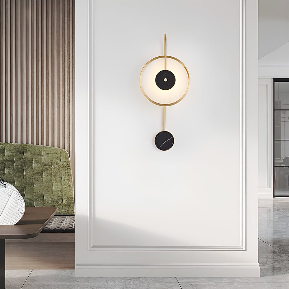 The Clérachic Orphaa on a bright panelled hallway wall, brass and marble reading as quiet jewellery at eye level.