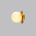 Clérachic Orrila sconce on grey, alabaster globe offset in front of a slim brass disc.