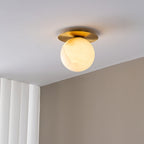 The Clérachic Orrila on a ceiling beside fluted white panelling, warm globe lit below.