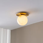 Clérachic Orrila ceiling light glowing against a white ceiling and ribbed wall panels.