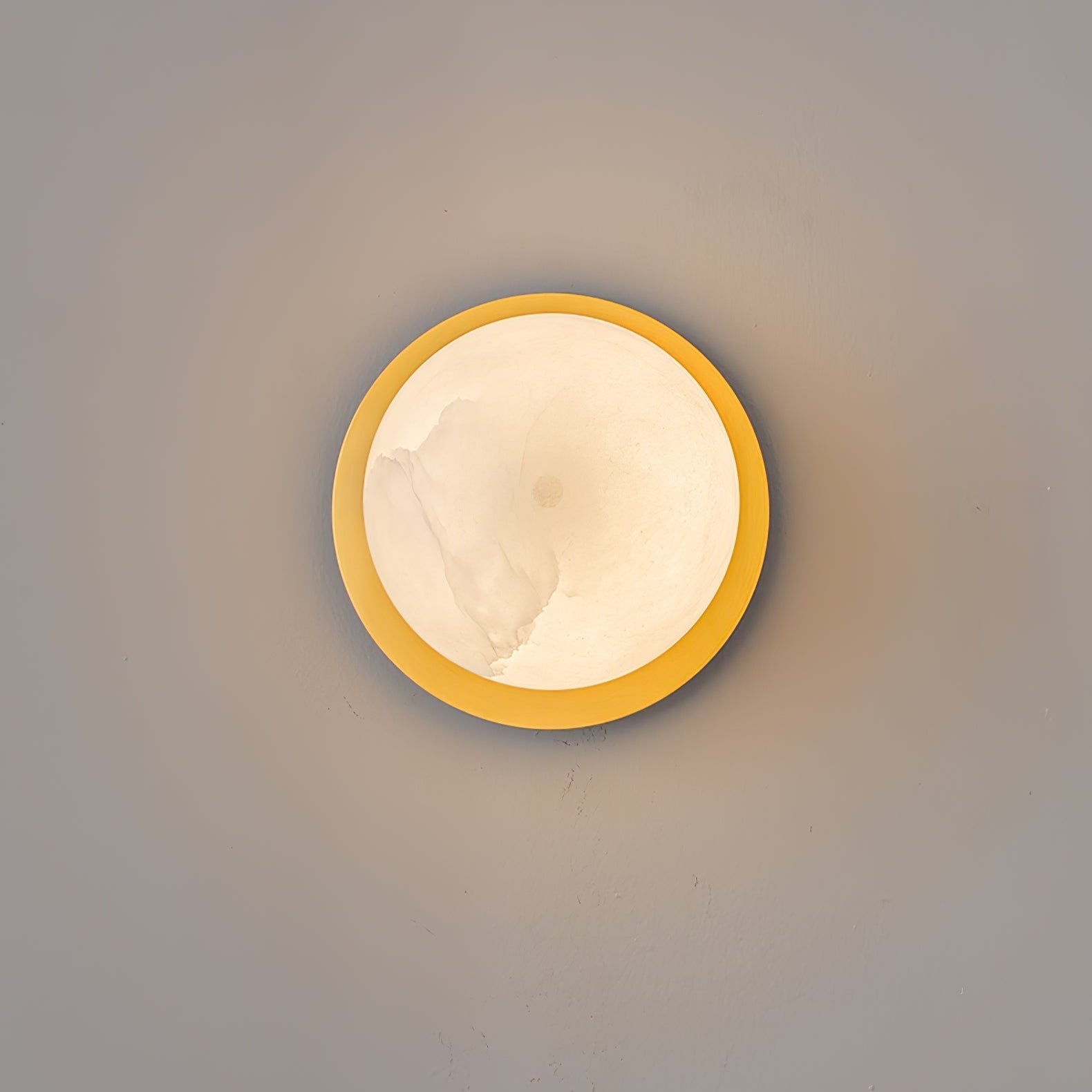 Clérachic Orrila seen straight on, brass ring encircling the lit alabaster face.