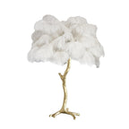 Clérachic table lamp with fluffy white ostrich feathers on a gold branch stem with splayed feet, on a plain white background.
