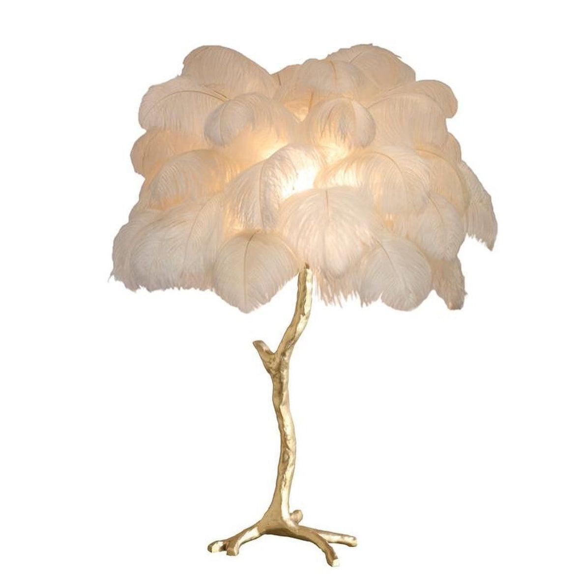 Clérachic table lamp with a lit cream-white feather shade on a gold branch stem, shown on a plain white background.