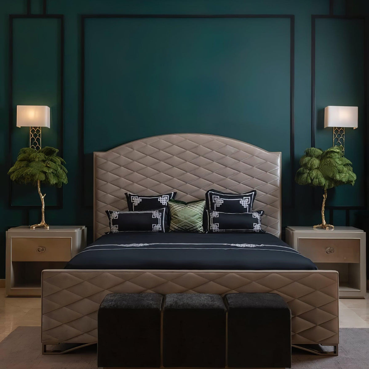 Two small Clérachic feather lamps with green plumes on bedside tables, either side of a quilted headboard on a deep teal wall.