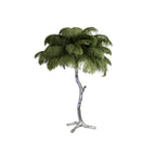 Clérachic table lamp with moss-green feathers on a silver branch stem, shown on a white background.