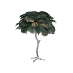 Clérachic table lamp with dark green feathers, lit from within, on a silver branch stem against a white background.