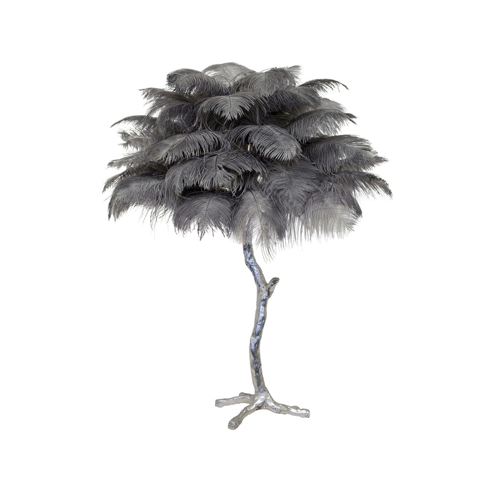 Clérachic table lamp with layered grey feathers on a silver branch stem with splayed feet, on a white background.
