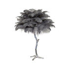 Clérachic table lamp with layered grey feathers on a silver branch stem with splayed feet, on a white background.