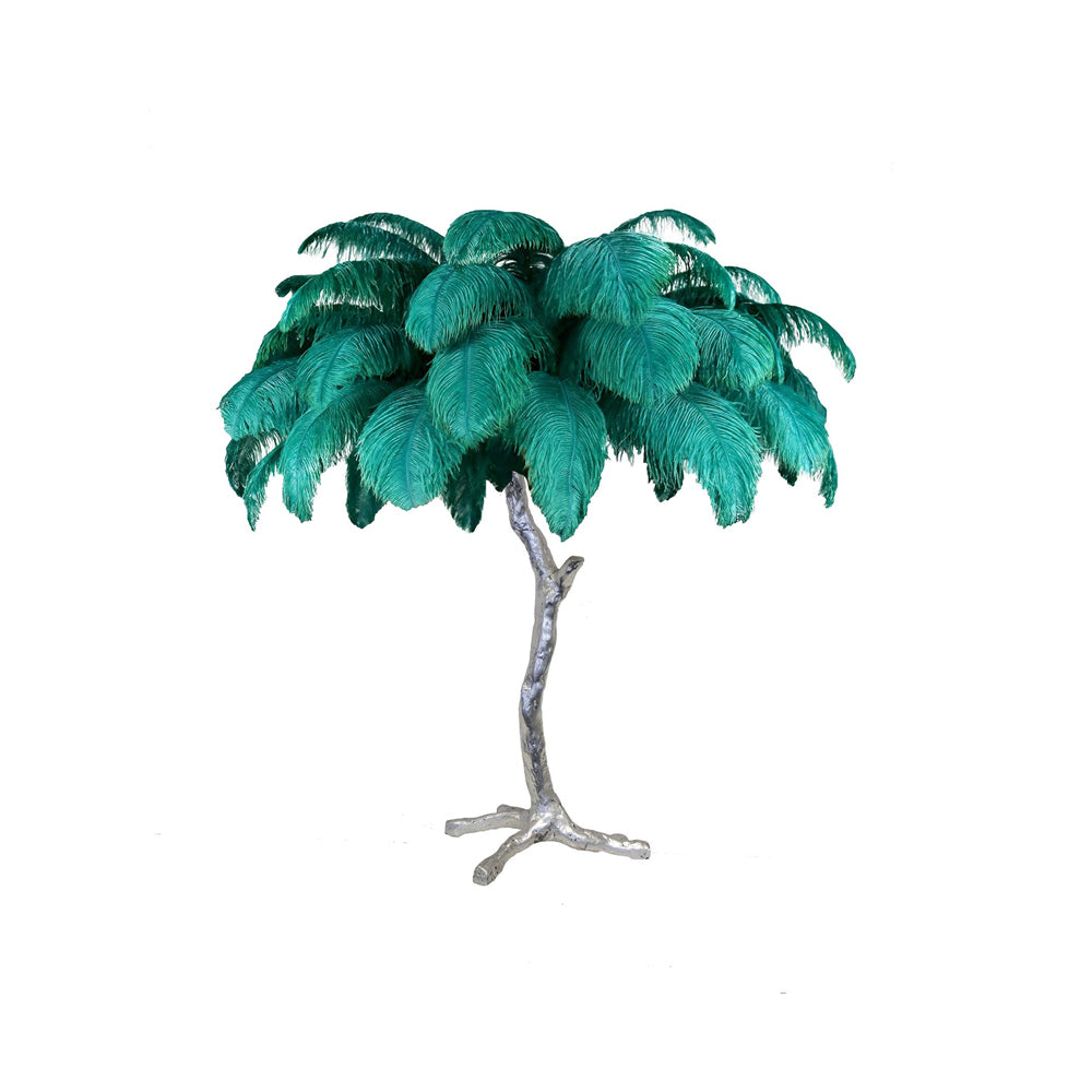 Clérachic table lamp with bright teal-green feathers on a silver branch stem with splayed feet, on a white background.