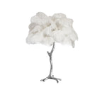 Clérachic table lamp with fluffy white feathers on a silver branch stem, shown on a white background.