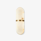 The Clérachic Ostruvyd in cream alabaster, brass band centred, photographed against a clean white studio wall.