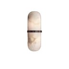 Clérachic pill sconce with a bronze-black band, cool grey veining marbling the alabaster above and below it.
