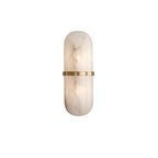 The Clérachic wall lamp in its smaller proportion, brass band set across a softly clouded alabaster panel.