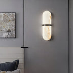The Clérachic Ostruvyd with its black band on a dark grey panelled wall, beside framed art in a living room.
