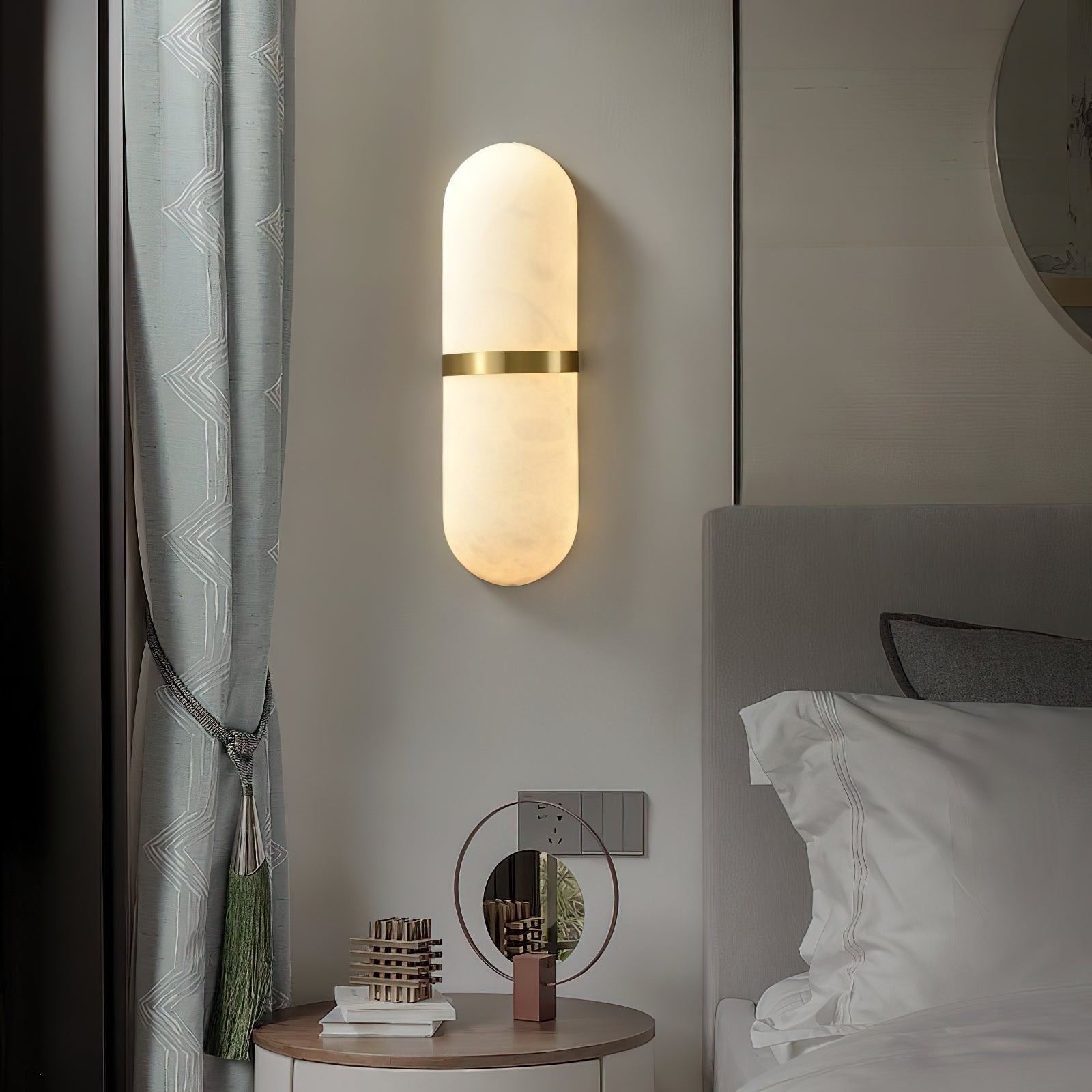 Clérachic wall lamp glowing beside a teal curtain and a round bedside table in a softly lit bedroom corner.