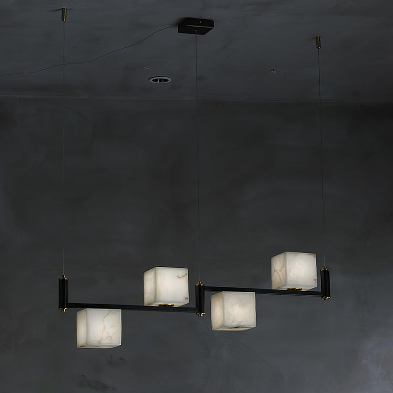 The Clérachic four-light bar seen wide, its four alabaster boxes reading as a low horizontal line of light.