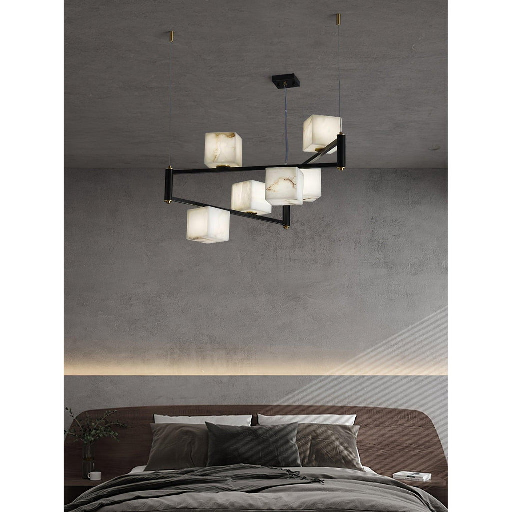 The Clérachic Ostruvye over a made bed, warm cube light layered with the cove lighting in the ceiling.