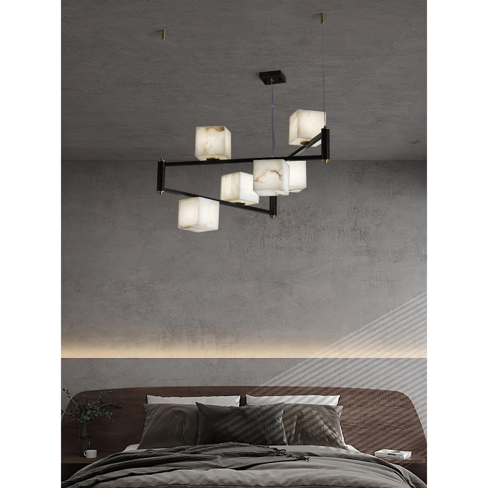 The Clérachic Ostruvye over a made bed, warm cube light layered with the cove lighting in the ceiling.