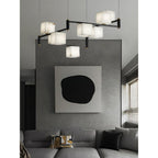 Clérachic box chandelier in front of a large abstract canvas, floating above a low grey sectional.