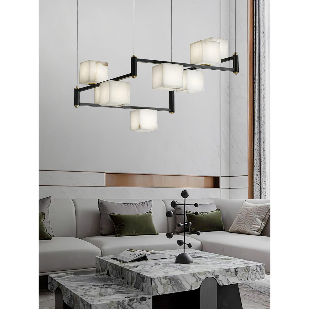 The Clérachic Ostruvye lit above a veined marble coffee table in an open, softly furnished living room.