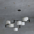 Clérachic eight-light chandelier viewed on the diagonal, the stepped arms clearly offset from one another.