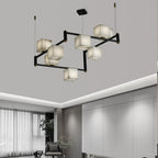 Clérachic box chandelier below a bright white ceiling, cubes lit against curtains and a low armchair.