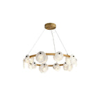 The Clérachic chandelier from just above, three fine cables lifting the brass hoop toward its round ceiling canopy.