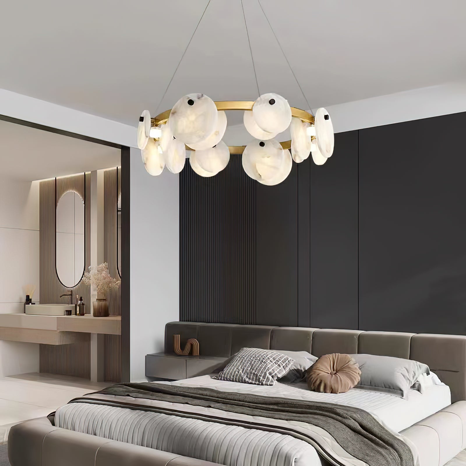 Clérachic chandelier above a low bed in a bedroom of dark timber panelling, alabaster discs catching the light.