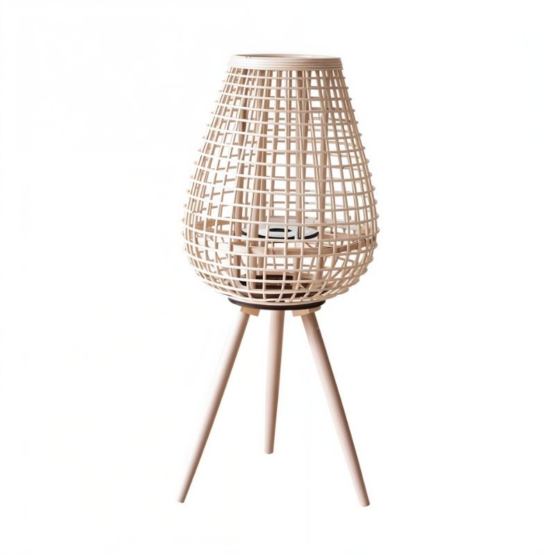 Clérachic tall teardrop lantern in pale woven cane on three tapered wooden legs, with a candle space inside.