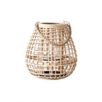 Clérachic squat woven cane lantern, rope handle clipped to metal hooks, with a dark base for a candle.