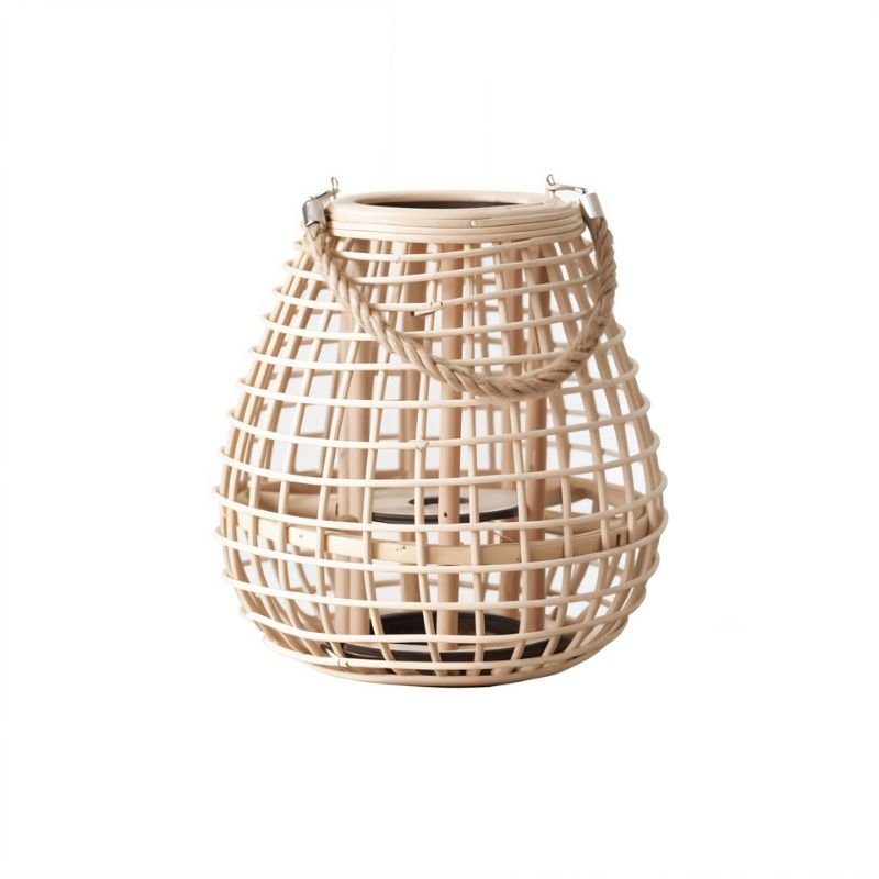 Clérachic squat woven cane lantern, rope handle clipped to metal hooks, with a dark base for a candle.