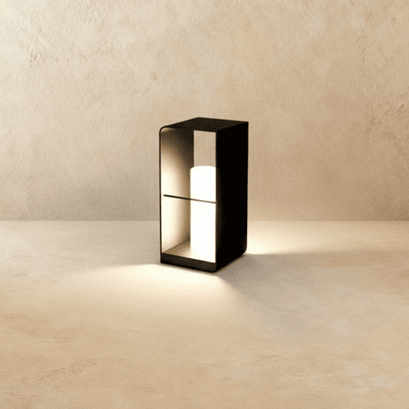 Clérachic medium black lantern with a lit white cylinder inside an open frame, casting a warm pool of light on the floor.