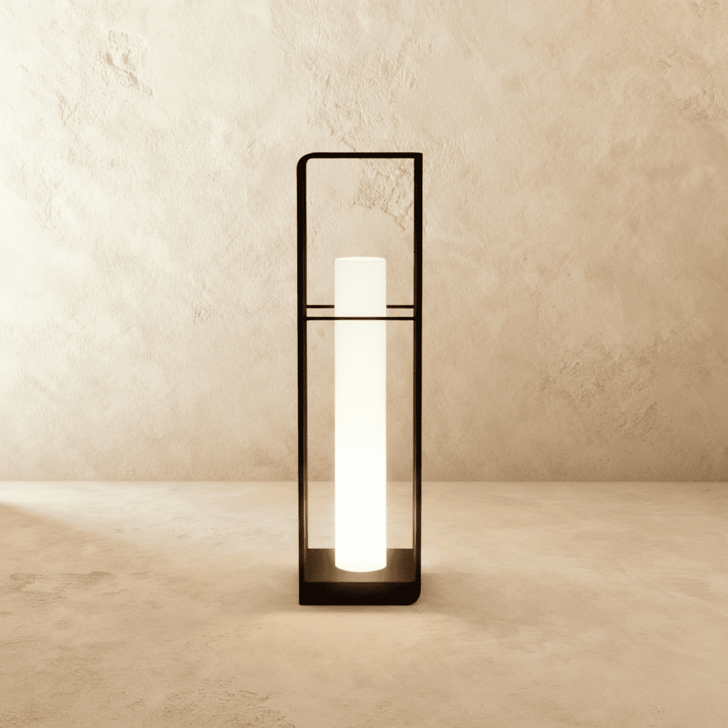 Clérachic tall black lantern with a long glowing white cylinder inside a slim open frame, shown against a textured wall.