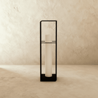 Clérachic large black lantern with its tall white cylinder unlit, a slim open metal frame on a stone-toned floor.